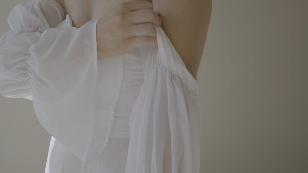 a bride gets prepared for her wedding day by entering into her dress