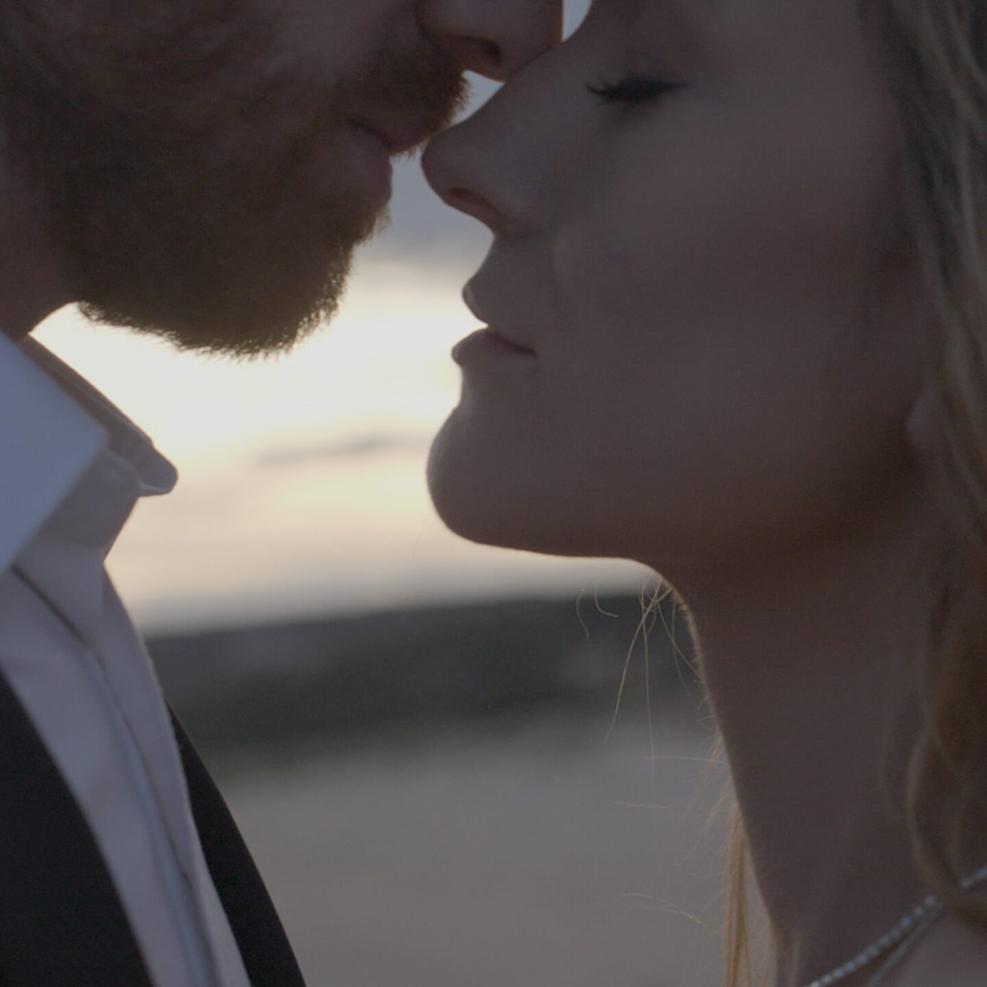 a couple kiss during their wedding film on a mornington peninsula beach